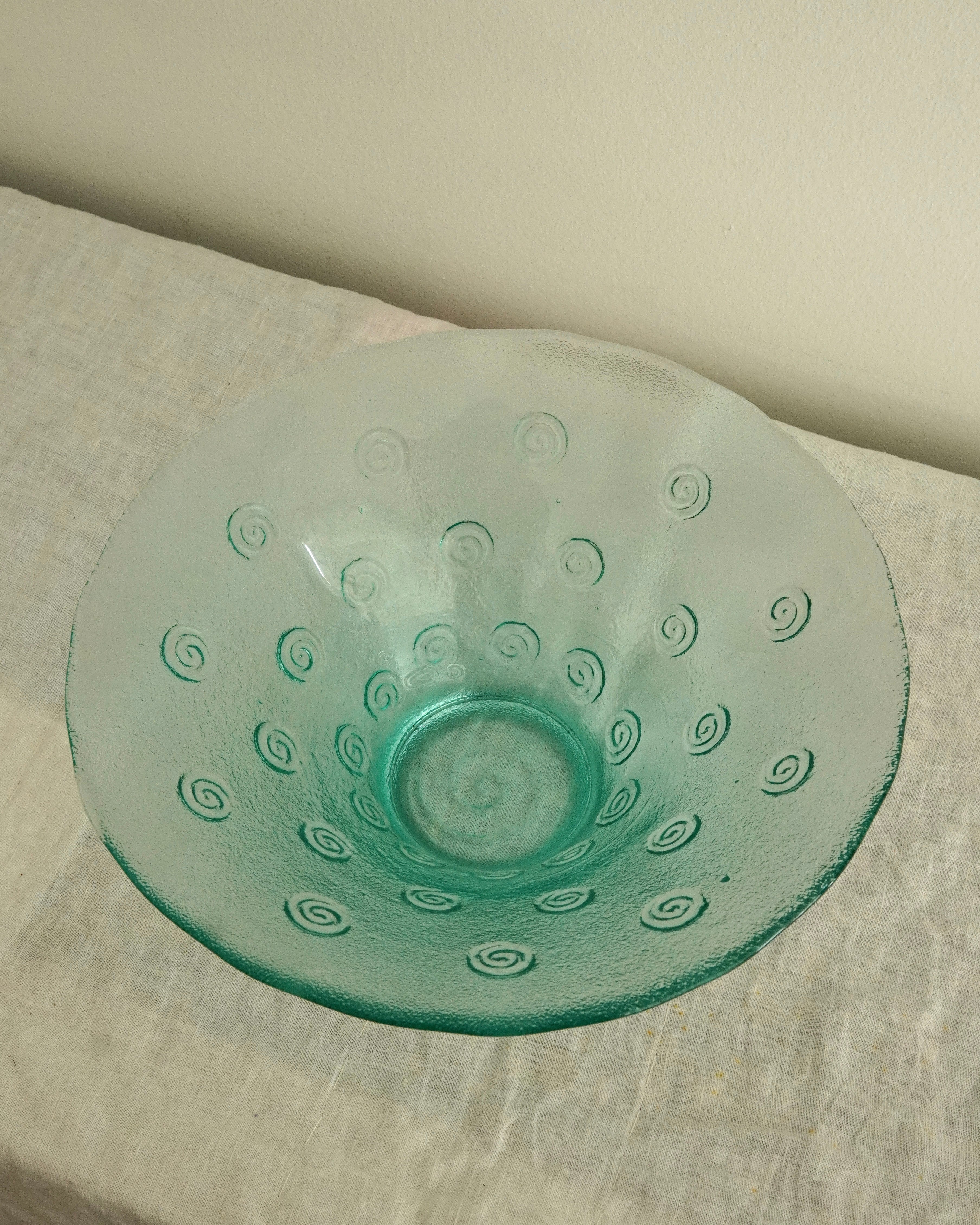 Tinted green glass swirl bowl