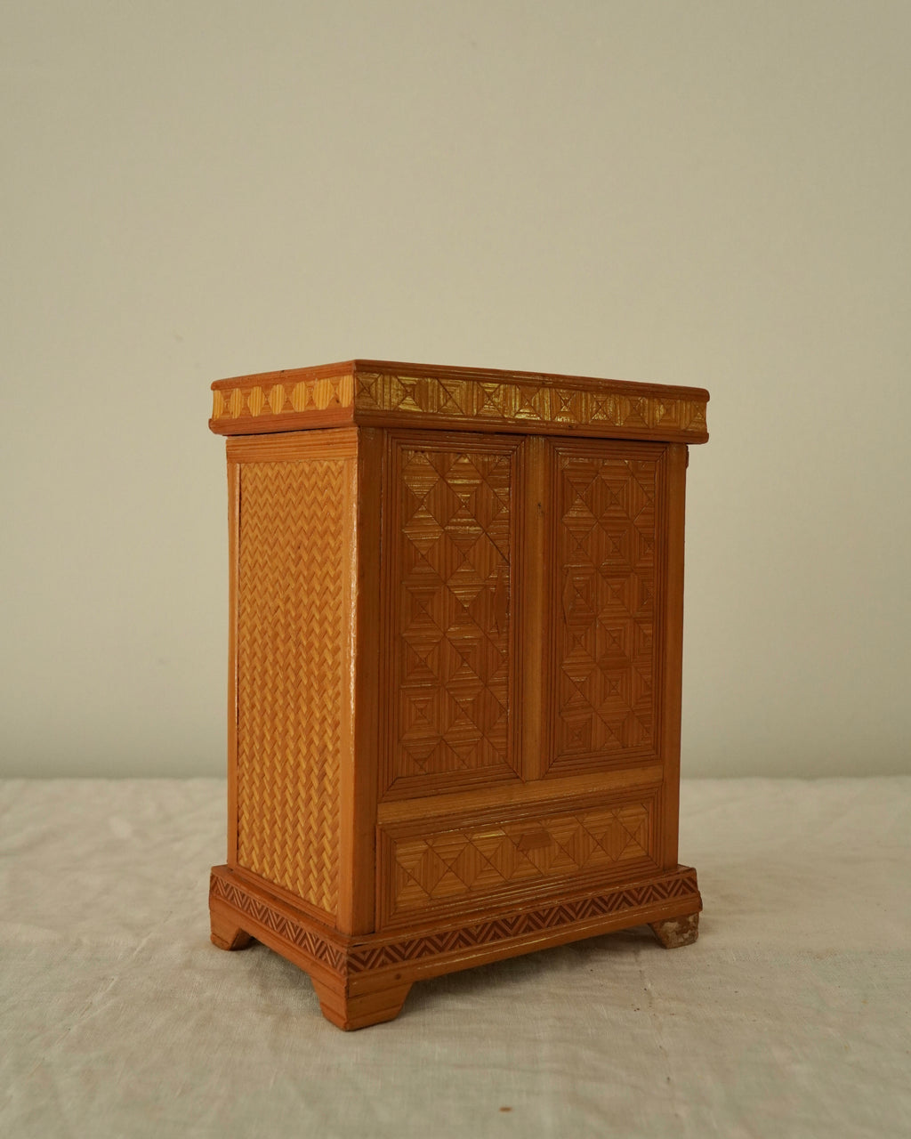Tramp art storage box in the design of a wardrobe