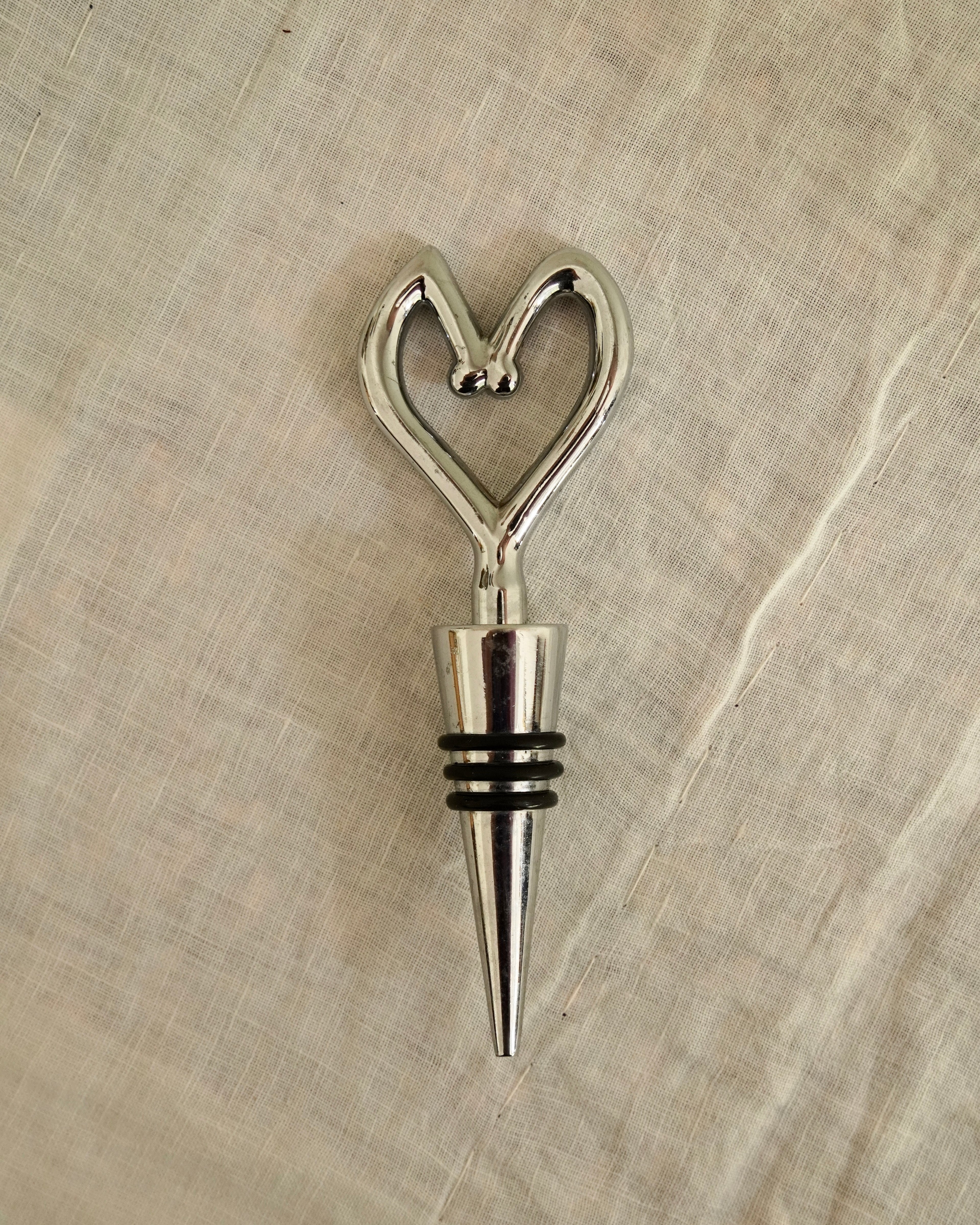 Heart shaped metal and rubber wine stopper