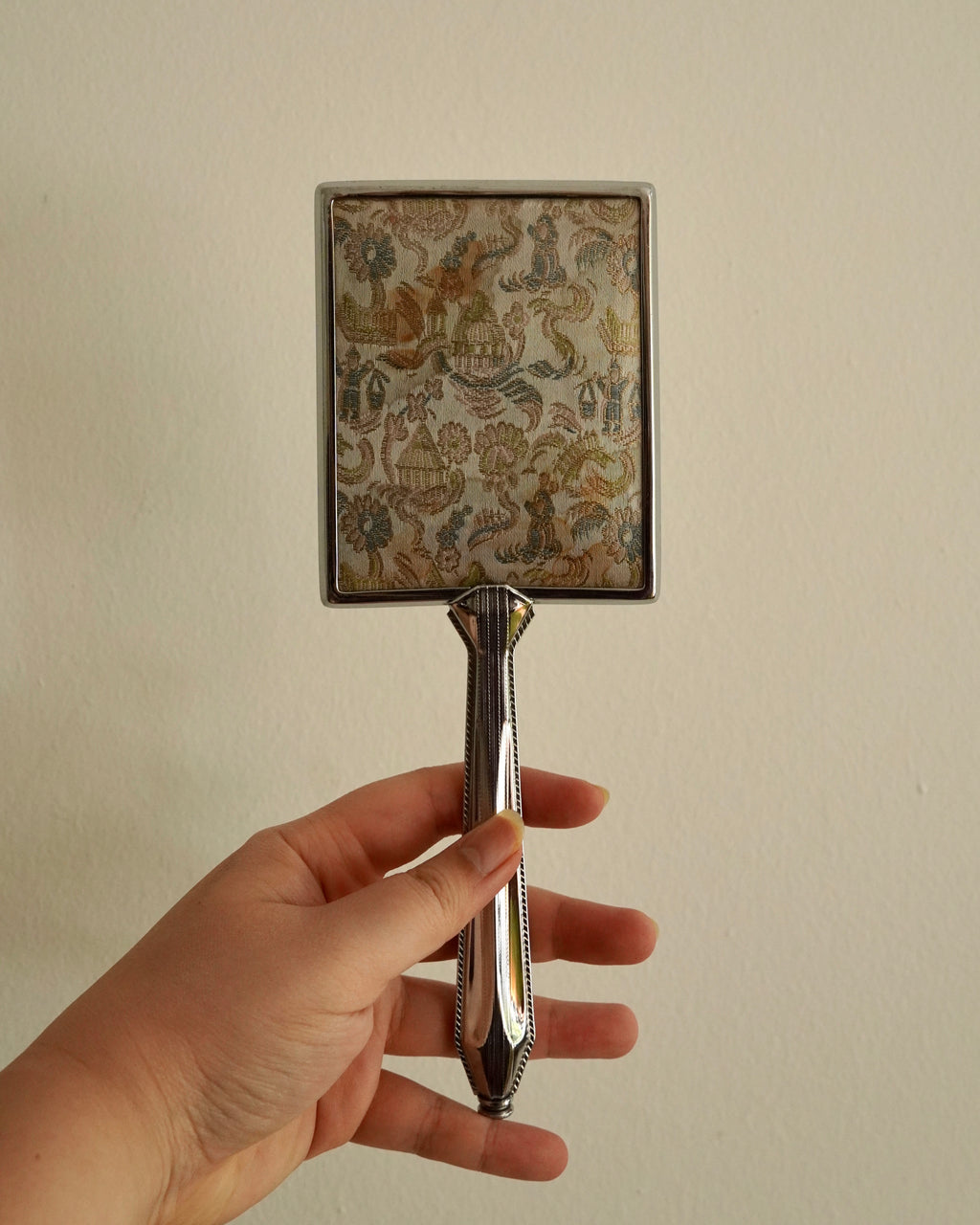 Silver handheld mirror with silk backing