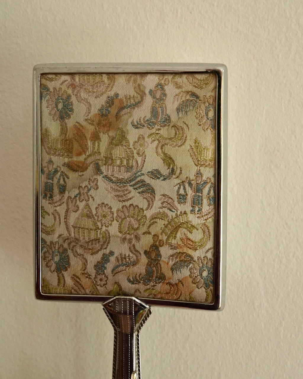 Silver handheld mirror with silk backing