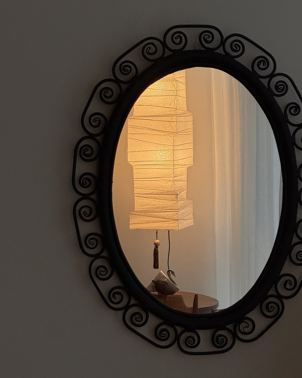 Woven rattan mirror with spiral edges in black