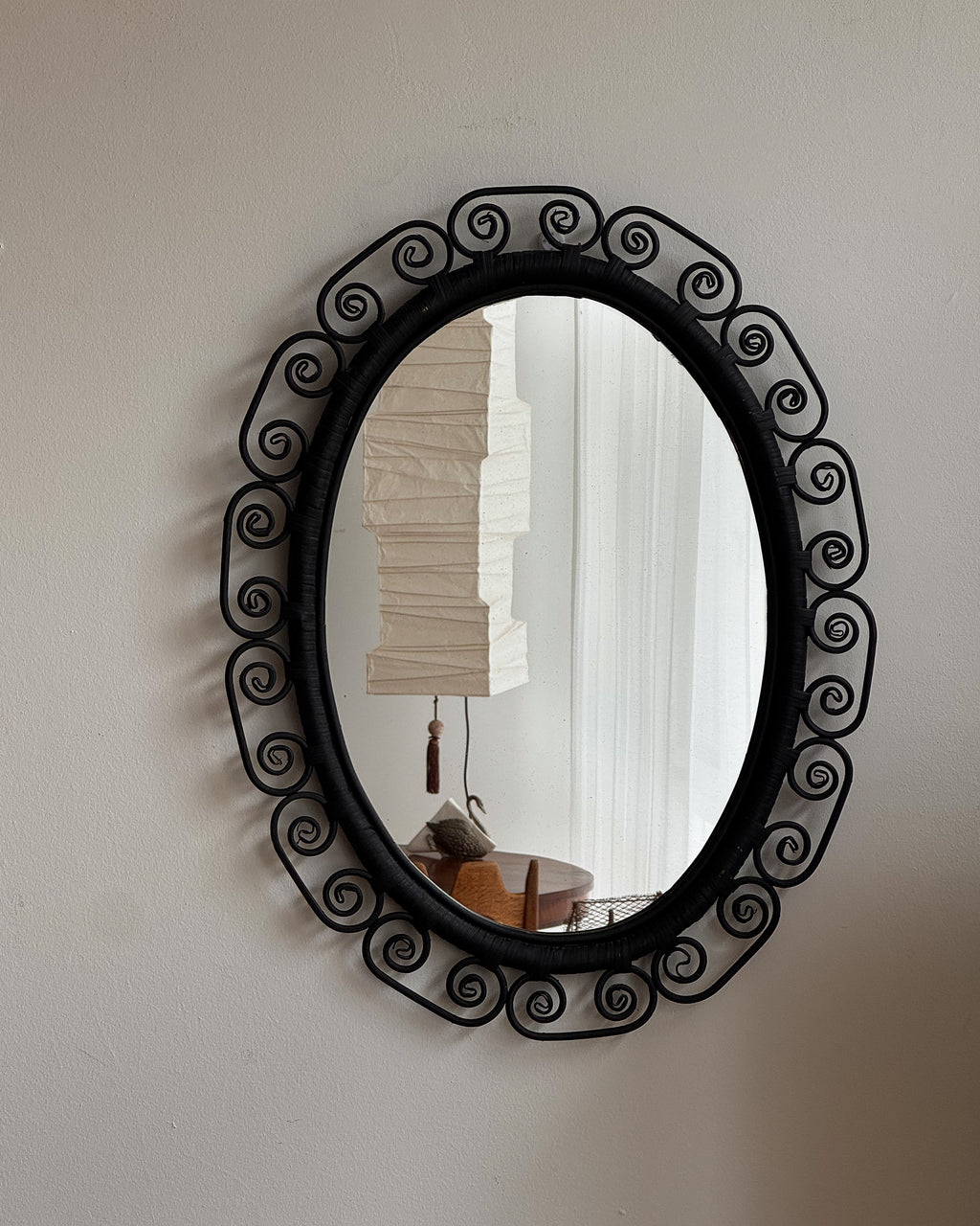 Woven rattan mirror with spiral edges in black