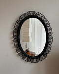 Woven rattan mirror with spiral edges in black