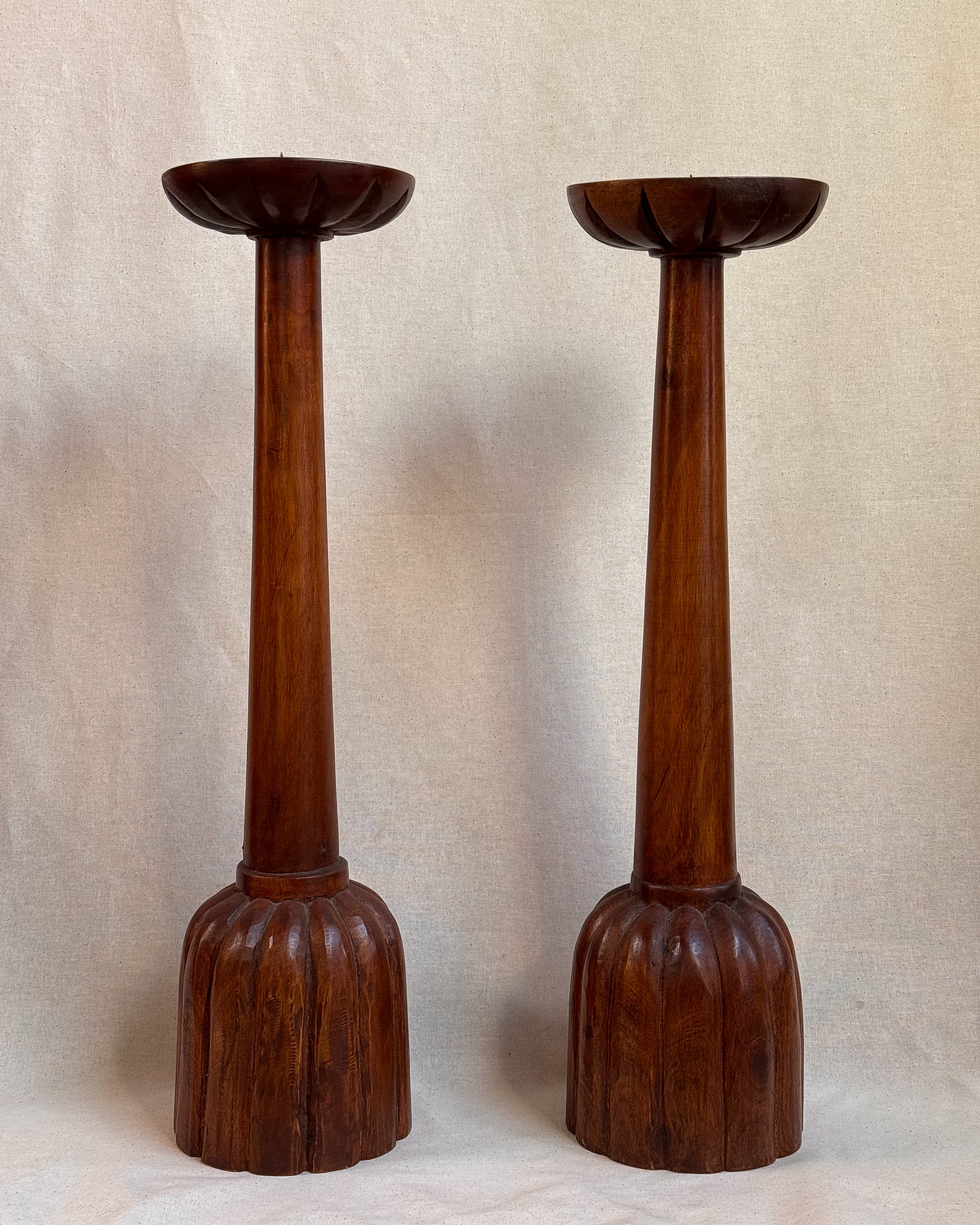 Carved wooden candle holders with canele shaped bases