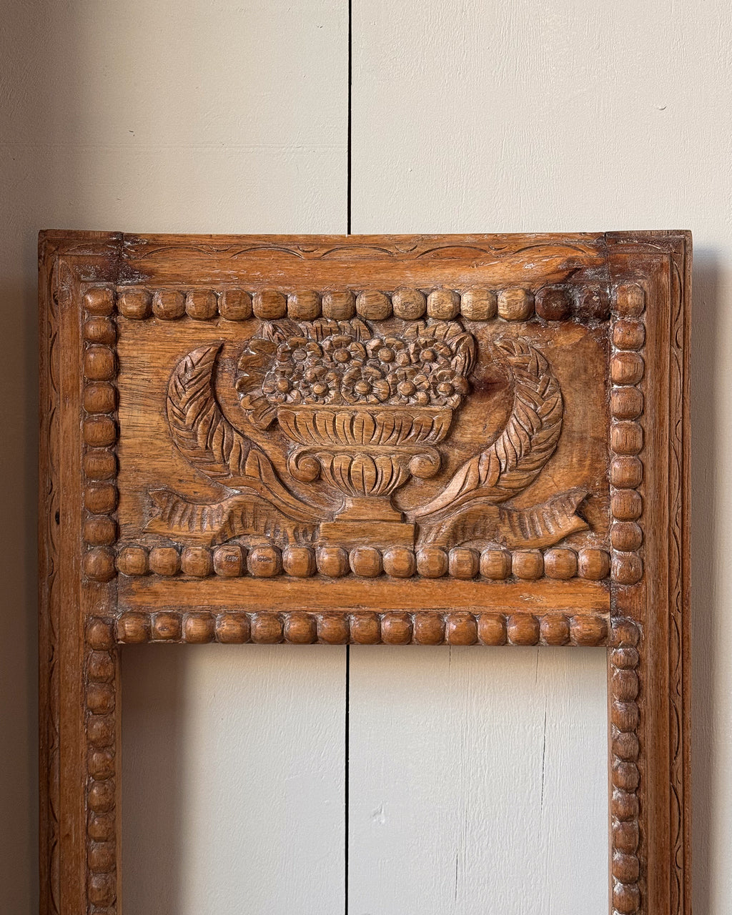 Hand carved wooden picture/mirror frame with clasical urn of flowers