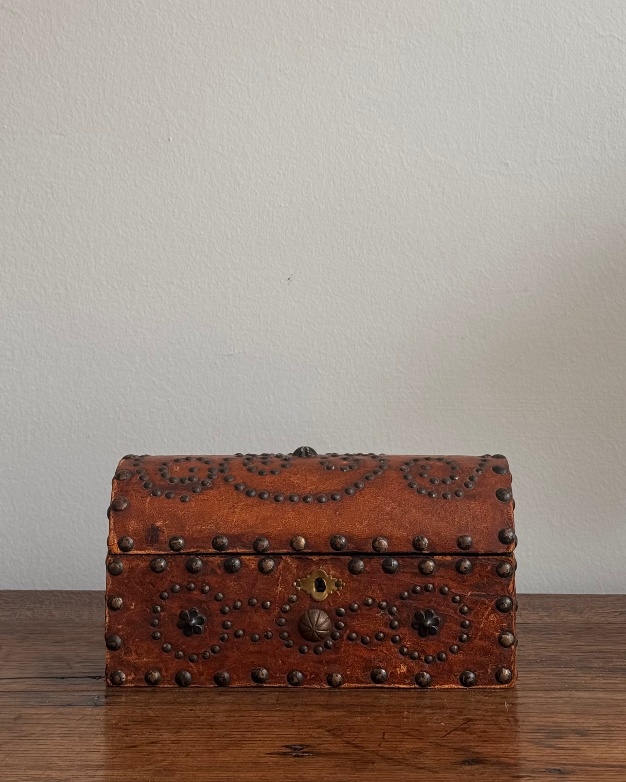Wooden box wrapped in leather and stud detailing
