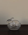 Clear glass bunny in a woven basket dish with lid
