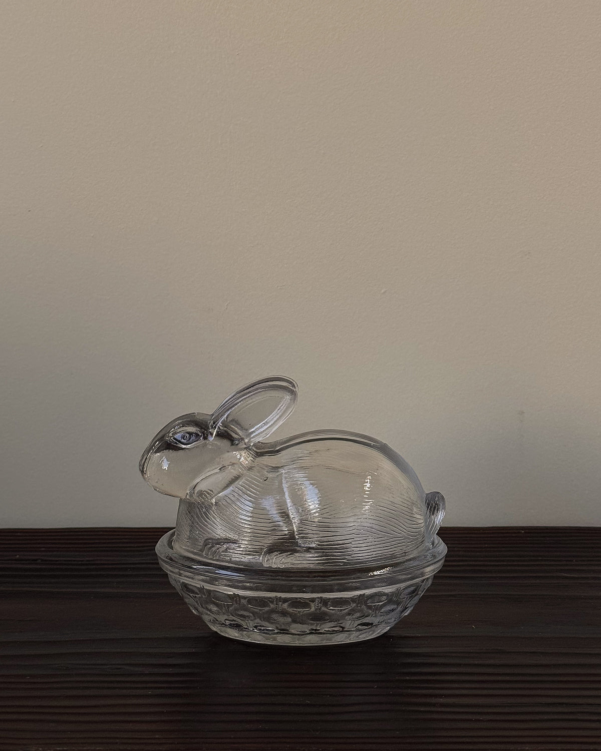 Clear glass bunny in a woven basket dish with lid