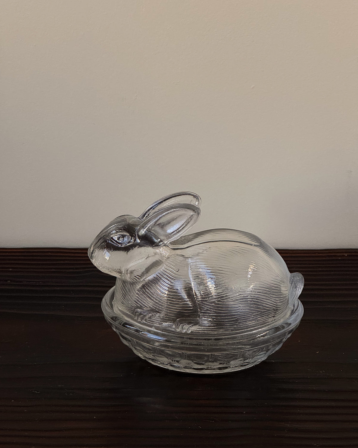 Clear glass bunny in a woven basket dish with lid