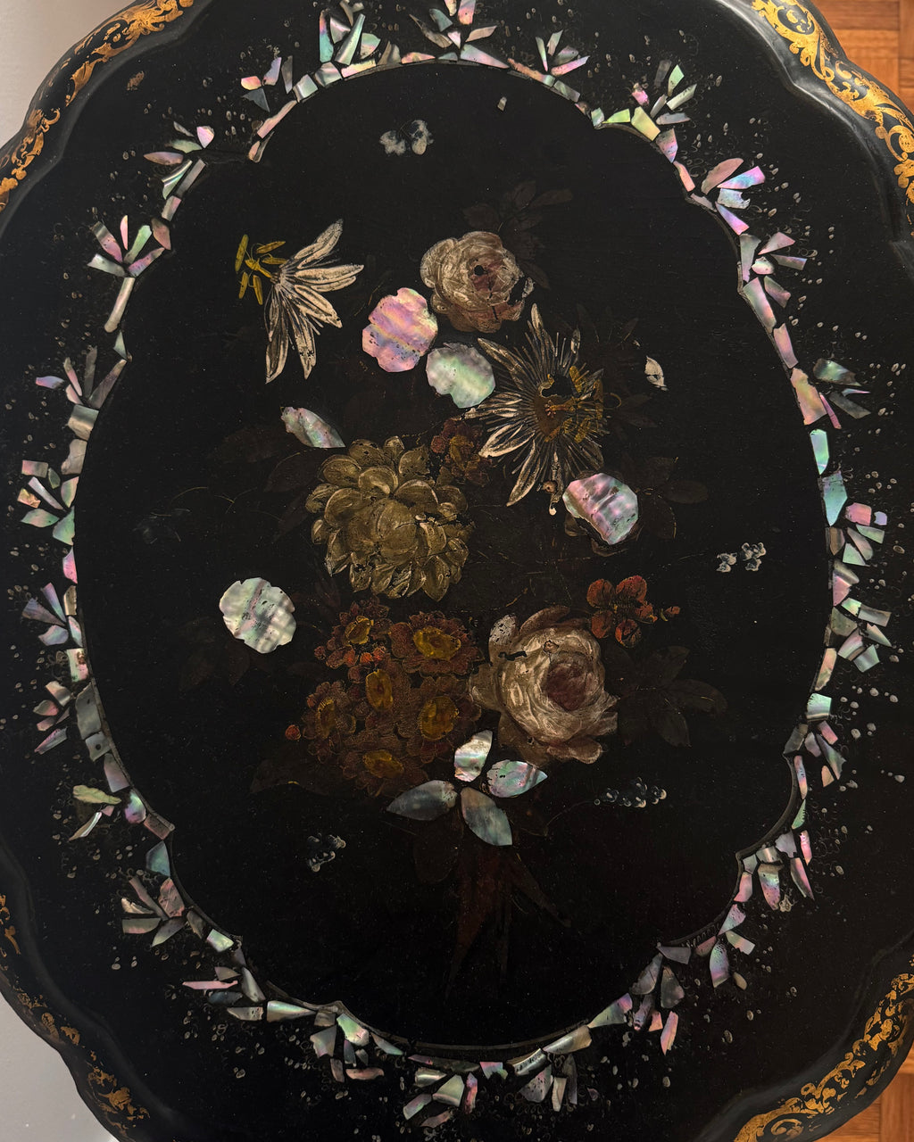 Paper mache and mother of pearl inlaid table likely made between mid to late 19th century