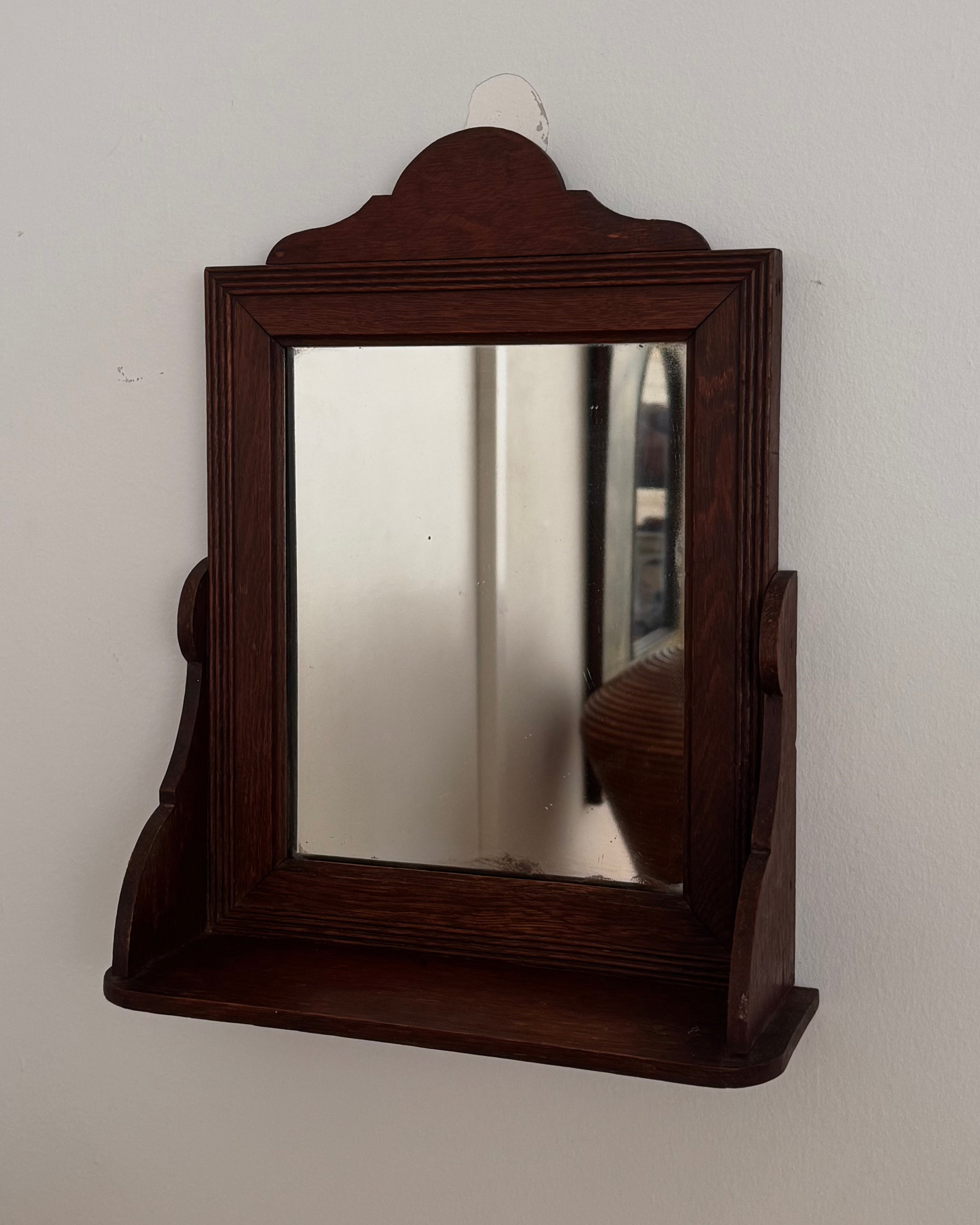 Dark wooden vanity or wall hanging mirror with ledge