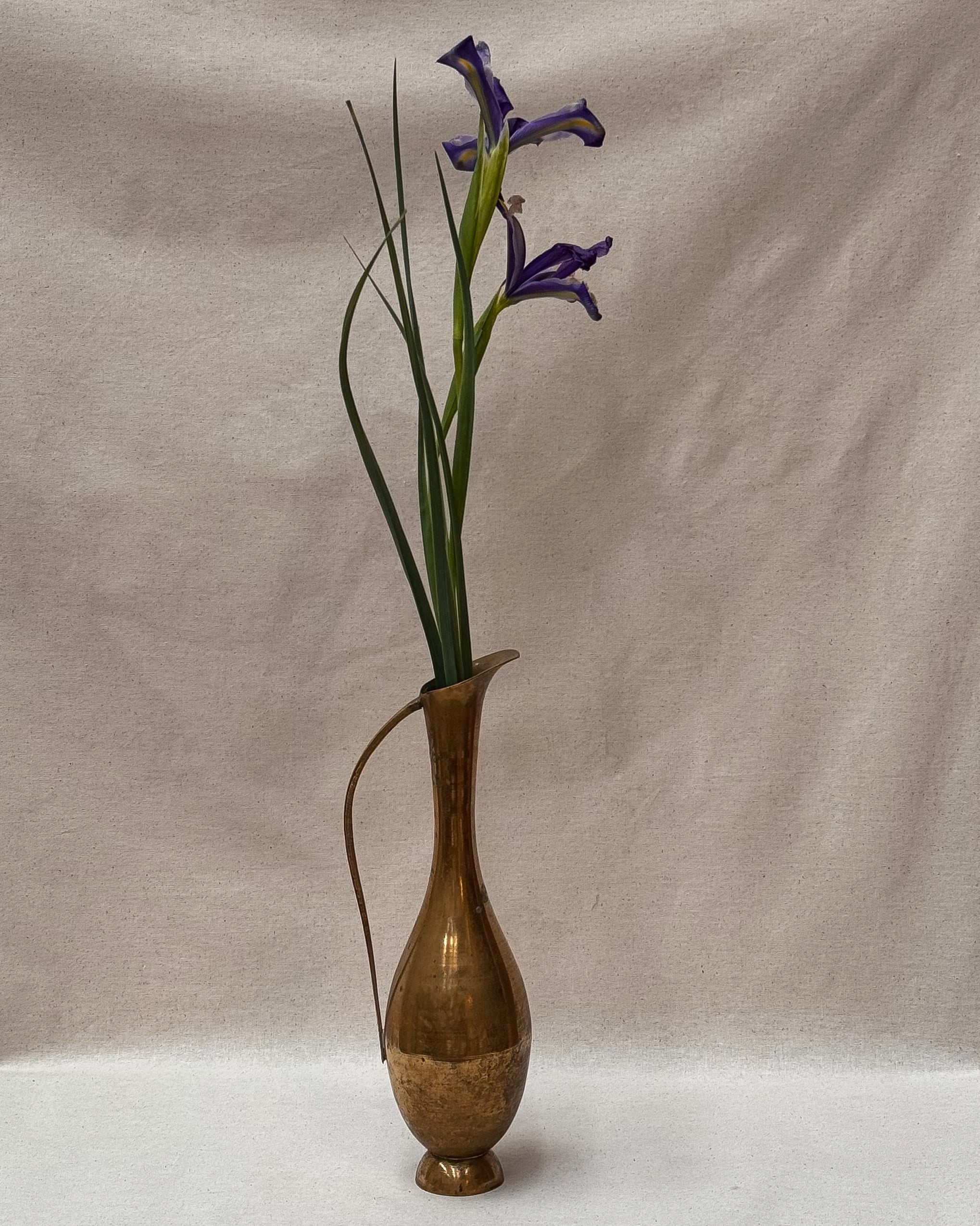 Tall brass vase with handle and tapered neck