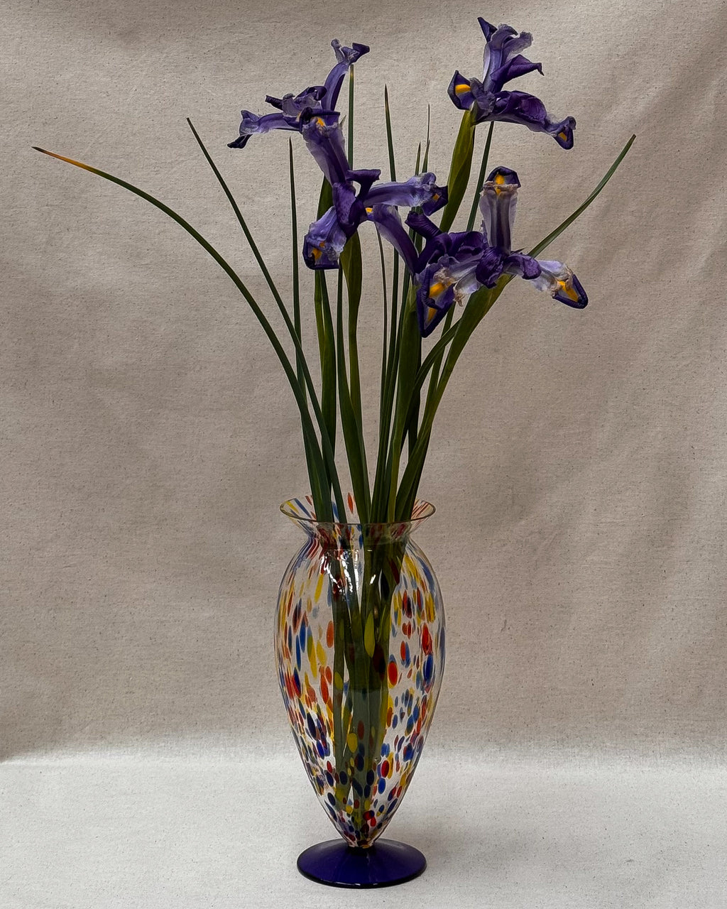 Art glass vase with colourful marks and blue base