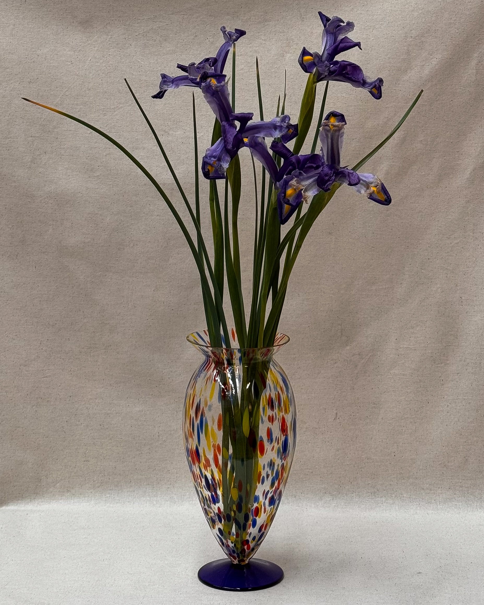 Art glass vase with colourful marks and blue base