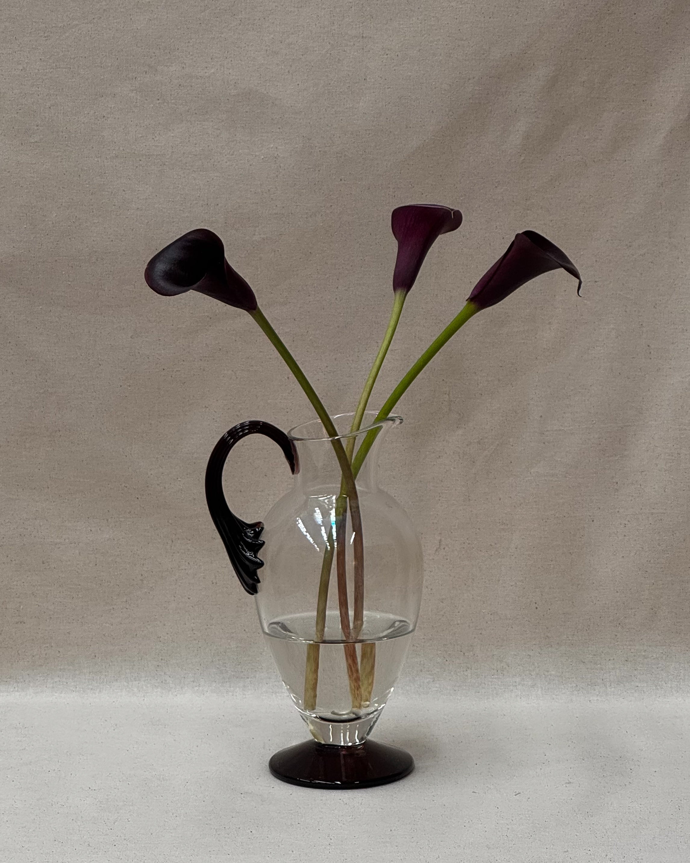 Glass pitcher vase with star like dark purple handle