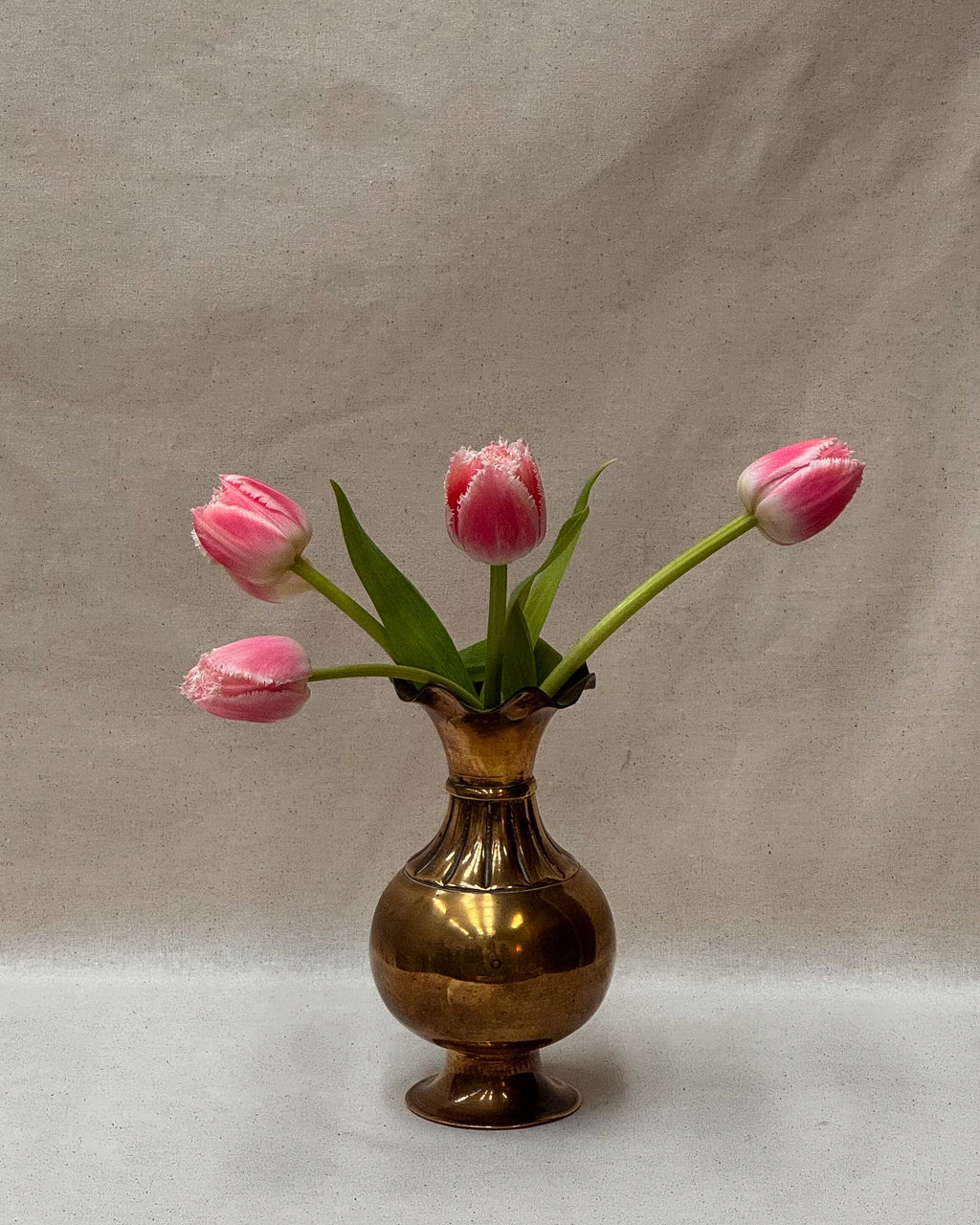 Brass vase with tapered neck and scalloped opening