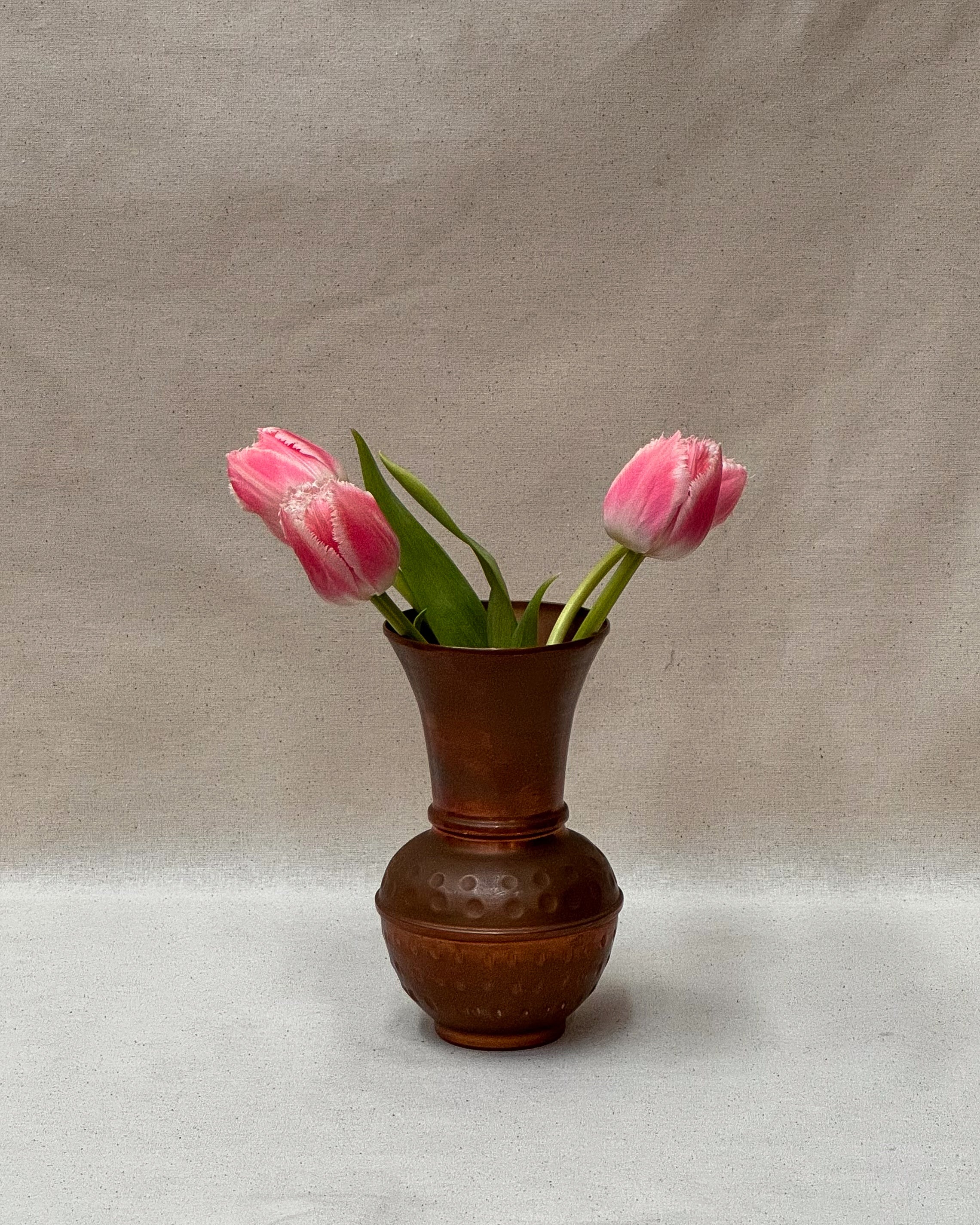 Hammered copper tapered vase with rounded base